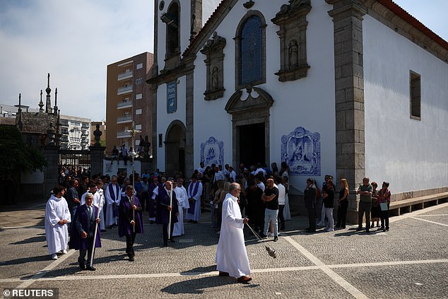 The congregation leaves the church in Gondomar following the funeral service on Saturday