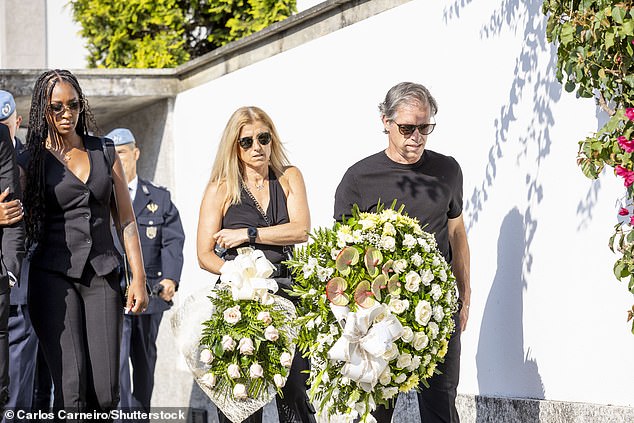 Comedian John Bishop, who is from Liverpool, carries a floral arrangement during the funeral of Diogo Jota and his brother Andre