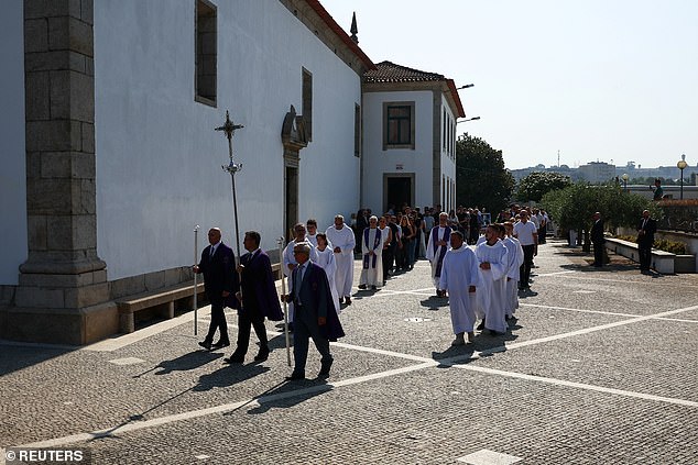 Members of the church lead the procession as its makes it way through the streets of Gondomar