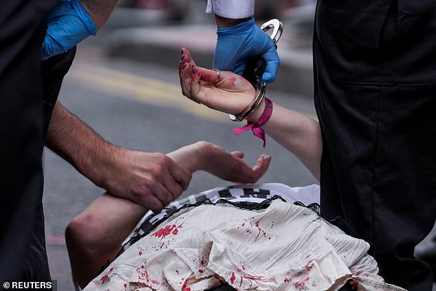 Police officers handcuff a "Youth Demand" activist, on the day of the 2025 Pride Parade in London