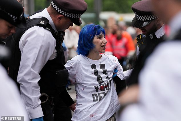 Police officers detain a "Youth Demand" activist, on the day of the 2025 Pride Parade in London