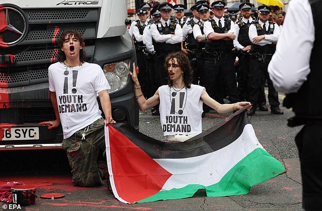 The parade was delayed for about an hour while the protesters were removed and five people arrested