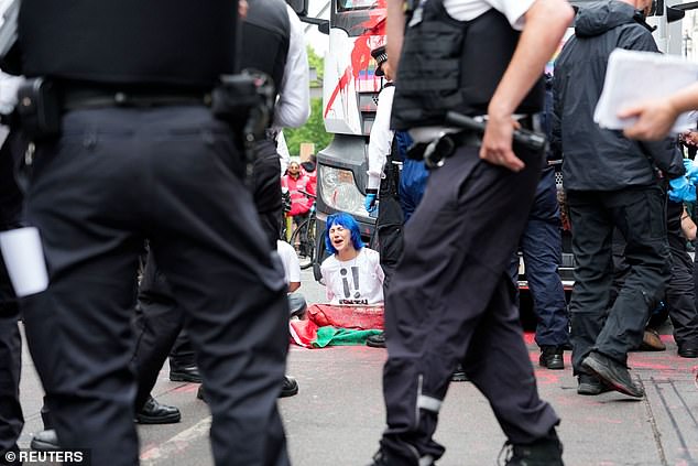 A "Youth Demand" activist reacts as she glues herself to a truck, on the day of the 2025 Pride Parade in London