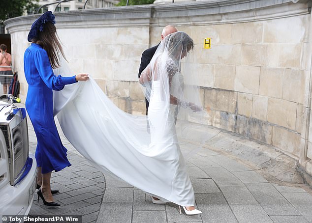 Mel's gorgeous gown was a bespoke design by Evelie Bridal Boutiques and featured a sheer illusion design adorned with white pearls and a ruched bodice