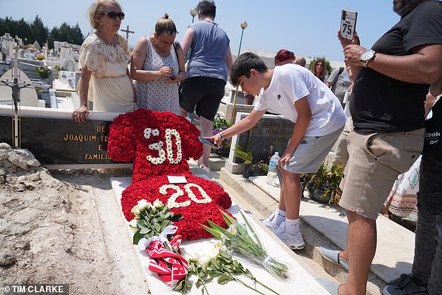Floral tributes bearing the shirt numbers of Diogo Jota and his brother Andre Silva are placed on their graves in a cemetery in Gondomar