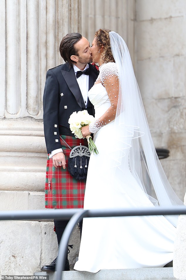 Spice Girl Melanie Brown, Mel B, and her husband hairdresser Rory McPhee kiss at St Paul's Cathedral, London, following their wedding