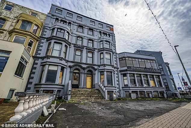Tourists looked up at the state of the Parisienne Hotel in shock as they walked past