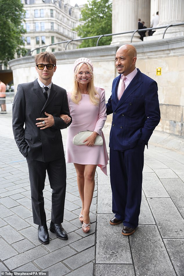 Husband Jade wore a navy suit with a pink shirt and tie, to match Emma's dress, whilst Beau wore a smart black suit and boots