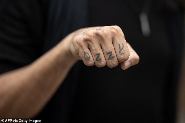 One diehard fan, Raphael Lima, was seen showing off his 'Ozzy' knuckle tattoo as fans from all over the world gathered at the event