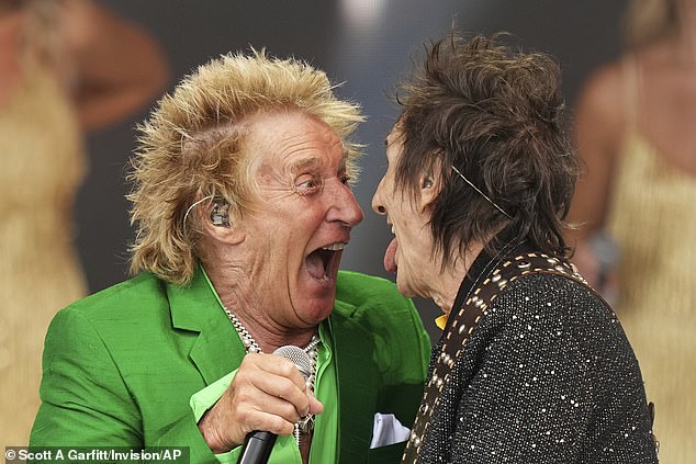 Meanwhile, fellow headliner Rod Stewart has said he is making a loss to play at Worthy Farm. Pictured: On stage with Ronnie Wood
