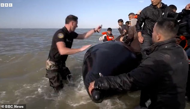 Dramatic scenes unfolded on a French beach as cops deflated a boat carrying migrants