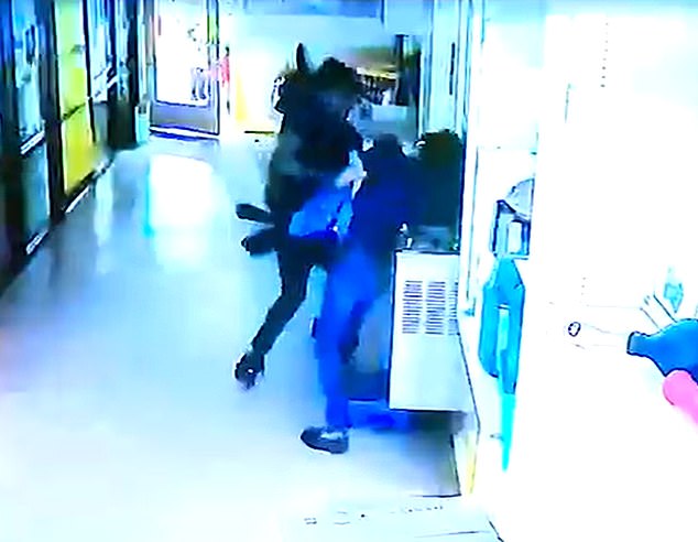 Nash confronted Montgomery outside the daycare before eventually forcing his way into the building and threatening to shoot her if she didn't leave with him and their daughter. Pictured: CCTV footage captured the moment Taco Nash assaulted Mi'ckeya Montgomery inside the daycare facility