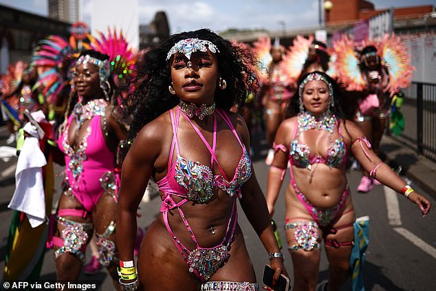 Performers in costume take part in the main parade of the Notting Hill Carnival in west London on August 26, 2024