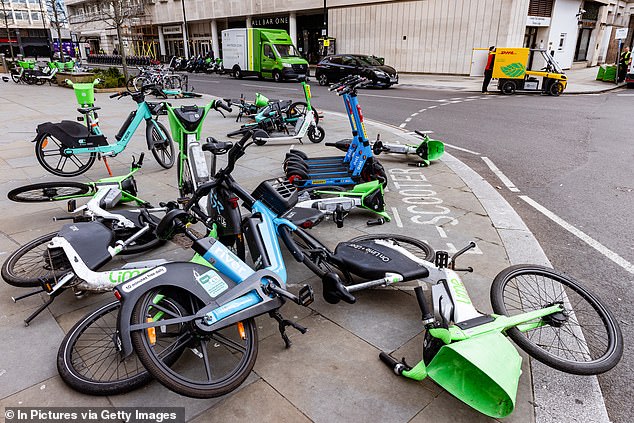 I know that us car drivers are meant to share the roads with others, but it¿s become nearly impossible to avoid a collision with some crazy idiot on two wheels. Pictured: Rental bikes scattered across a pavement in London