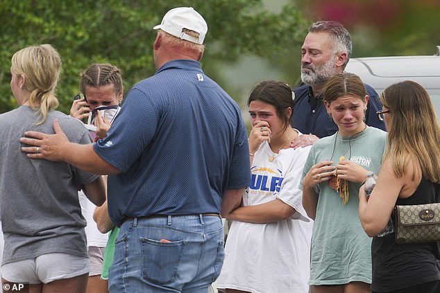 Search and rescue efforts remain the top priority in central Texas, according to Kerrville City Manager Dalton Rice, as crews continue to search for the missing along the Guadalupe River. Pictured: People comfort each other outside the Butt-Holdsworth Memorial Library in Kerville after heavy rainfall caused the Guadalupe River to flood and damage several communities in Central Texas