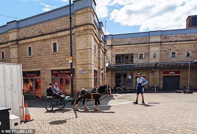 Two men ride a horse and trap through Rawson Place where locals have described it as a 'no go zone'