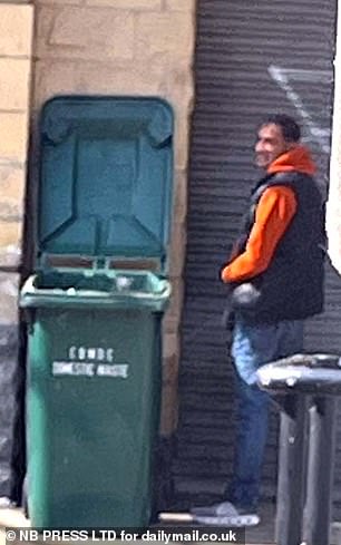 A man urinates by a bin in the Rawson Square area of Bradford