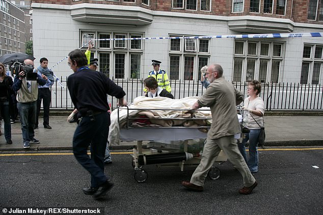 A victim of the explosion is stretchered to a waiting ambulance