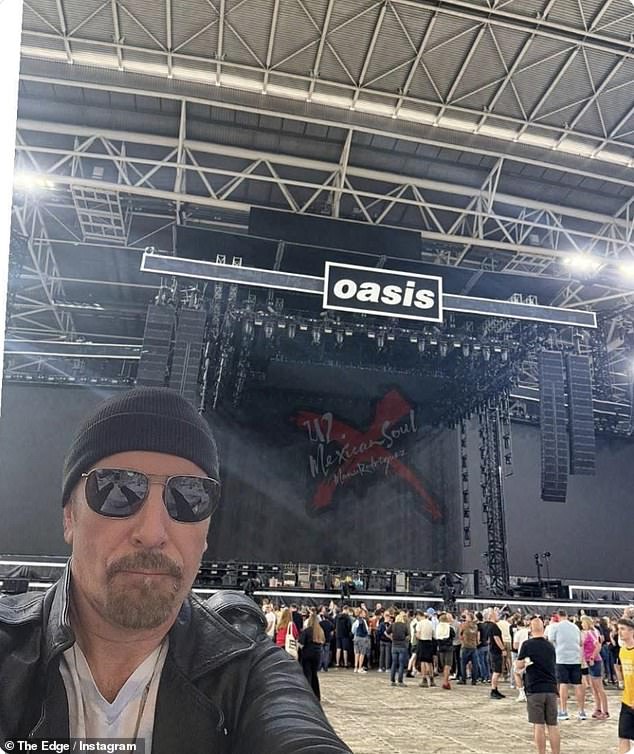 While U2's The Edge was also in the crowd, snapping a selfie in front of the stage on Saturday night, ahead of the show (pictured)
