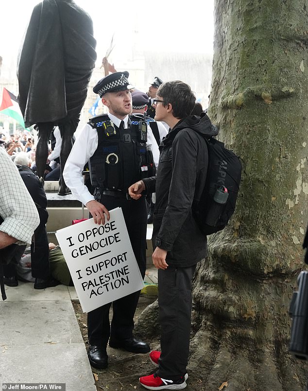 Police officers speak to protesters as they prepared to make arrests after Palestine Action was proscribed as a terrorist organisation