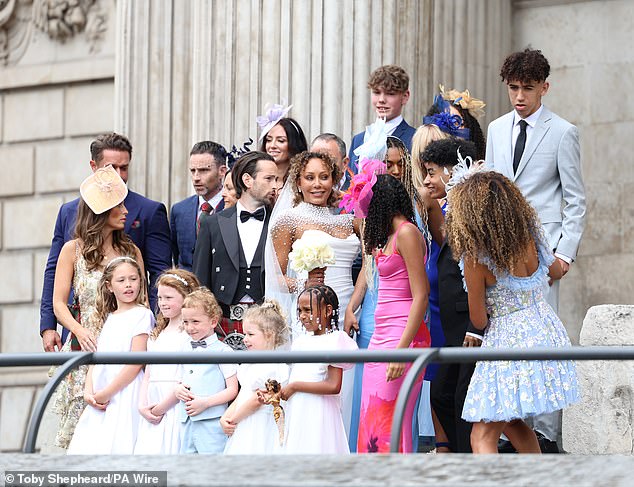Friends and family gathered with the newlyweds to take pictures outside the iconic venue
