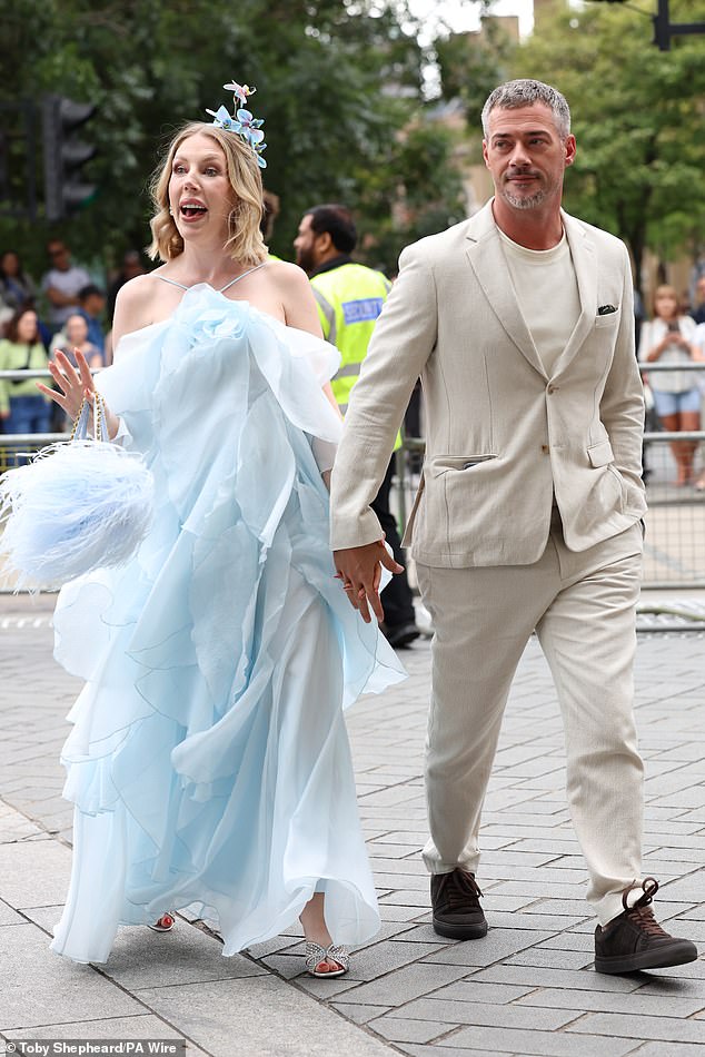 Katherine Ryan looked radiant in a ruffled pale blue gown as she held hands with husband Bobby Kootstra