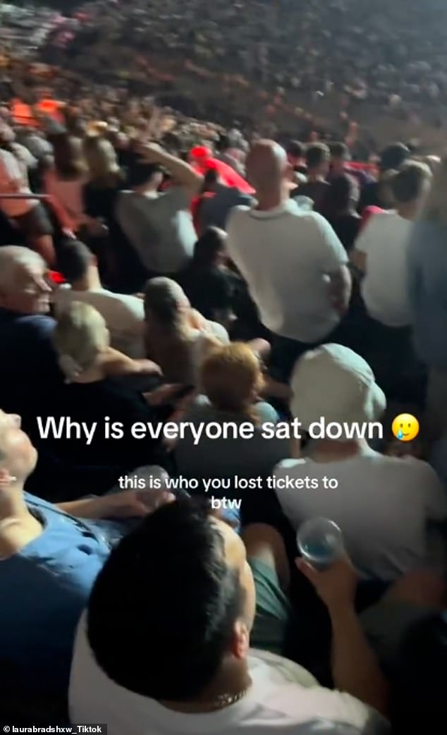 As she scanned the crowd many appeared to be taking the opportunity of a slower song to have a rest and sit down