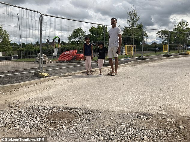 Don Jose, 40, with his children Maybel, aged eight, and Malot, aged four, wants developer Keepmoat to finish the roads and open the play area near their home