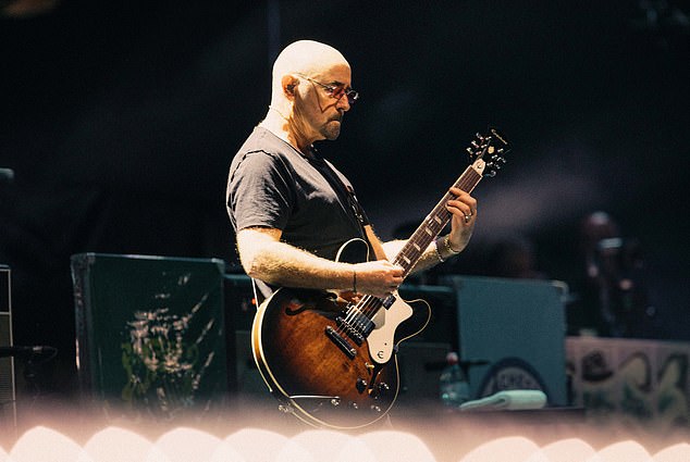 Getting emotional at times during the night, when the band returned for their encore Noel directed the audience to cheer for Bonehead (pictured) saying: 'On guitar, if it wasn't for him, none of this would have happened!'