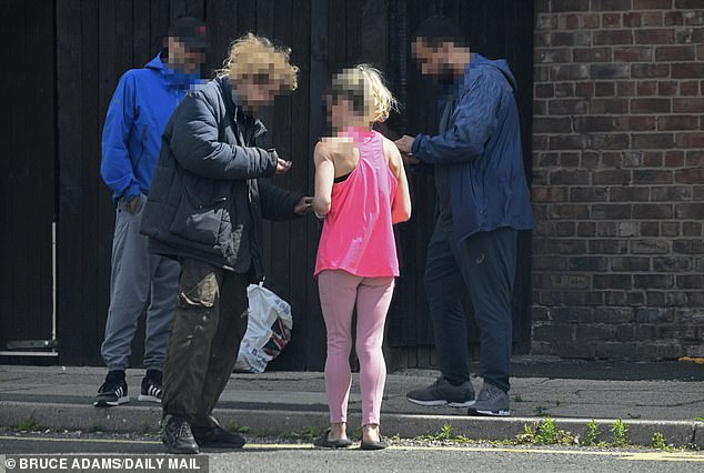 Two people negotiate a drug deal near the back of a pub in Walton, Liverpool