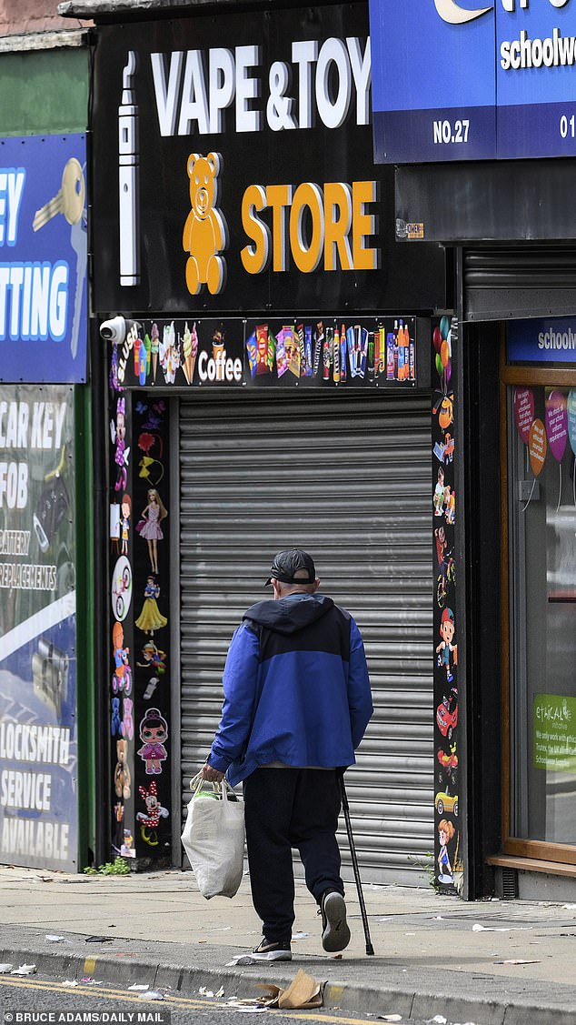 A resident walking past a 'Vape and Toy Store'. Locals told of how the area that was once 'fantastic' has declined