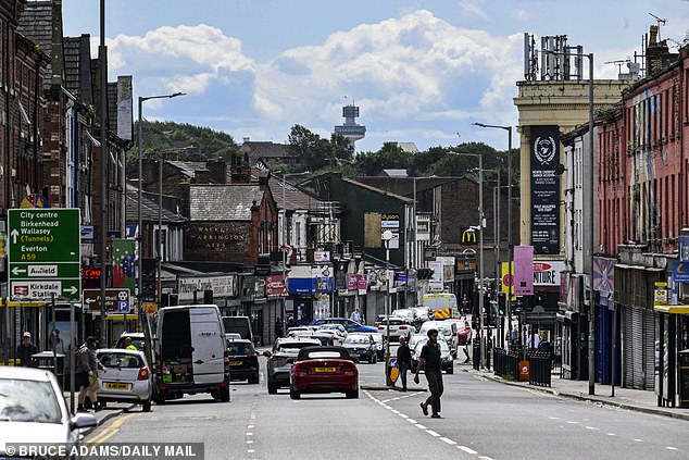 A view of Walton Road. The high road was busy with traffic but a large number of shops were sat empty and shuttered