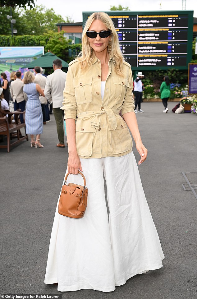 She looked happy and healthy as she arrived for the sporting event in a flared white jumpsuit which she wore with a beige jacket