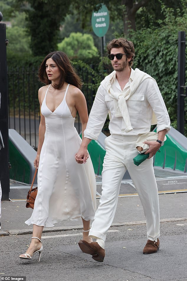 She showed off her incredible figure in a strappy white top as they appeared to confirm their romance - after first sparking relationship rumours in February this year