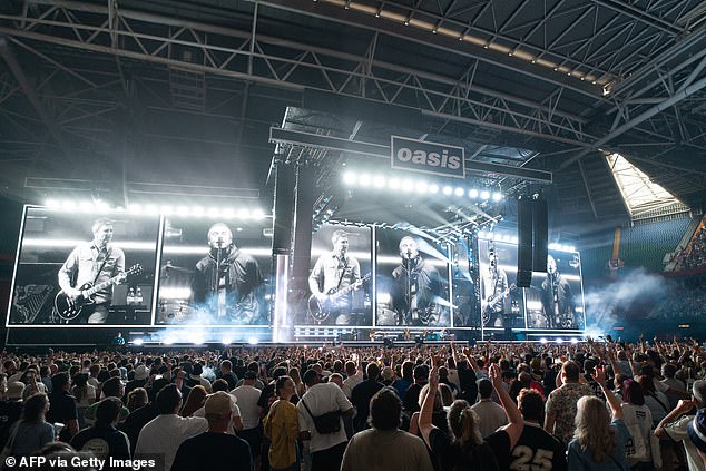 British rock band Oasis perform on stage at the Principality Stadium in Cardiff on July 4, 2025
