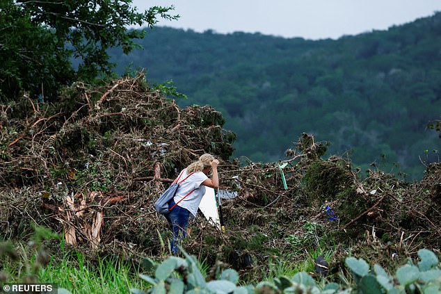 A woman searches the area, following flash flooding, in Hunt, Texas, U.S. July 6
