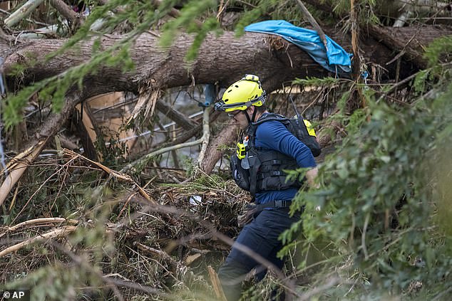 First responders from College Station Fire Department search along the banks of the Guadalupe River, as rescue efforts continue following extreme flooding, Sunday, July 6, 2025, in Ingram, Texas