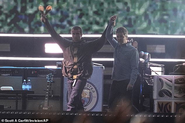 After years of feuding, brothers Liam (left) and Noel Gallagher (right) linked arms in Cardiff