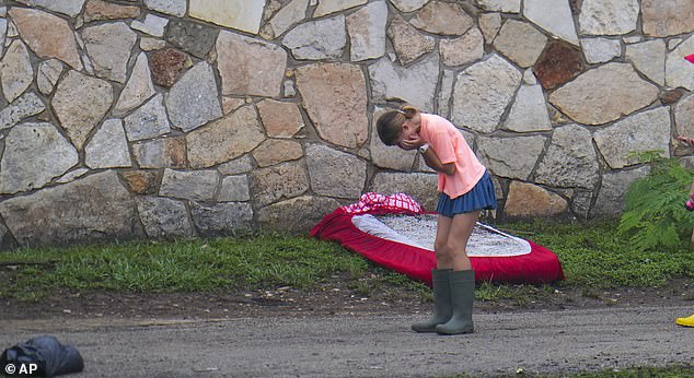 A girl reacts in the area outside sleeping quarters at Camp Mystic