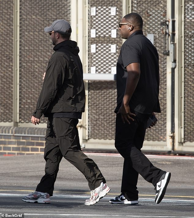 Justin looked relaxed as he stepped out in a black shiny tracksuit which he layered over a black hooded jumper