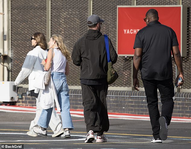 He finished his travelling ensemble with a pair of white and grey running trainers s he kept a low profile with a grey cap