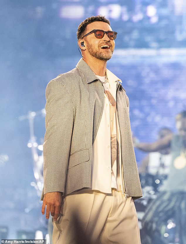 For his headlining set, Timberlake sported the distressed, custom shirt alongside white pants, a matching button-down shirt and a checkered blazer jacket
