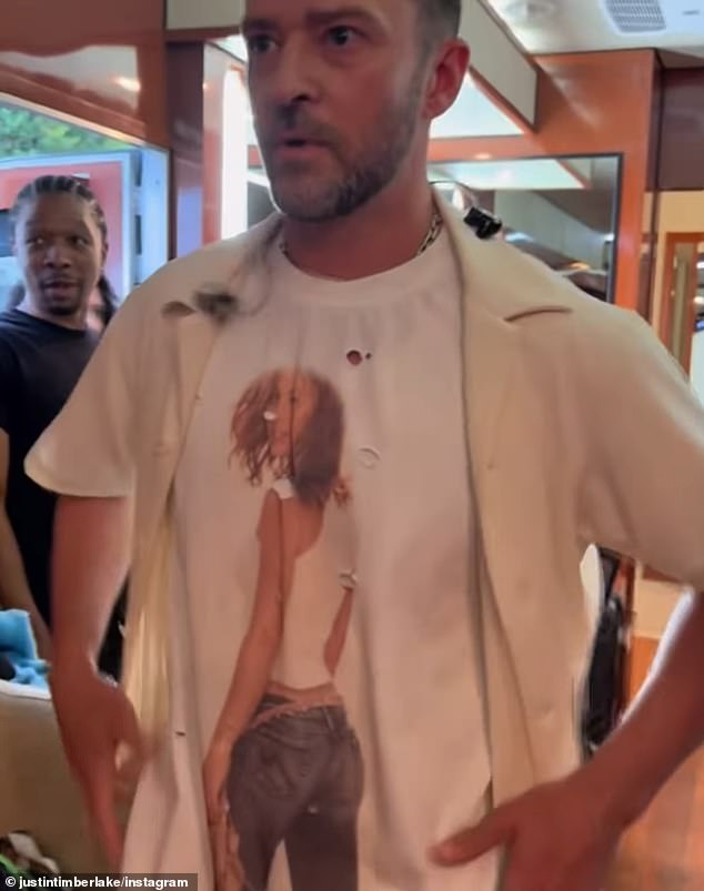 But her jaw dropped open and she placed a hand in front of her face to hide her surprised reaction when he opened his blazer jacket to reveal he was wearing a shirt of her on it too