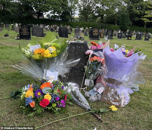 Brightly-coloured bouquets were left by relatives who visited the scene and comforted each other at the site of the tragedy