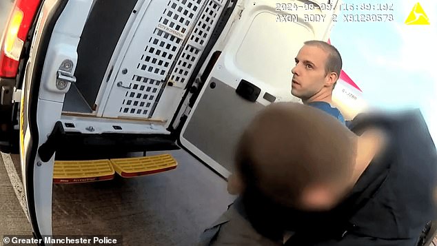 A gaunt John Belfield is marched into the back of a police van after being flown back to Britain