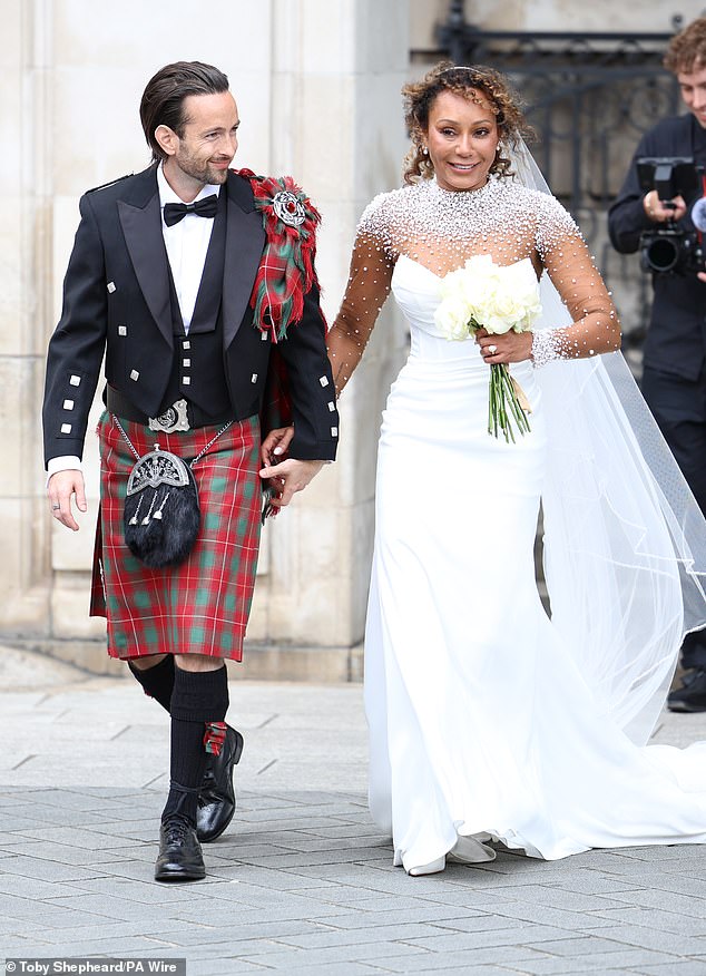 Her gown featured a sheer illusion design adorned with white pearls and a ruched bodice, with the singer adding a flowing veil to her bridal look