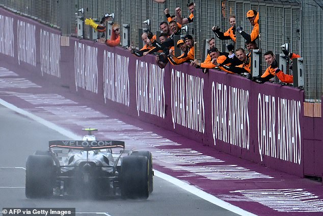 McLaren crew members pictured celebrating as Norris crossed the finish line at Silverstone
