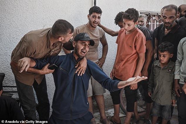 Relatives of the Palestinians who lost their lives mourn their loss following the Israeli airstrikes that targeted Abu Asi school, which hosts displaced Palestinians in the Shati Refugee Camp in Gaza City, Gaza, killing over 50 Palestinians, including women and children, on July 6