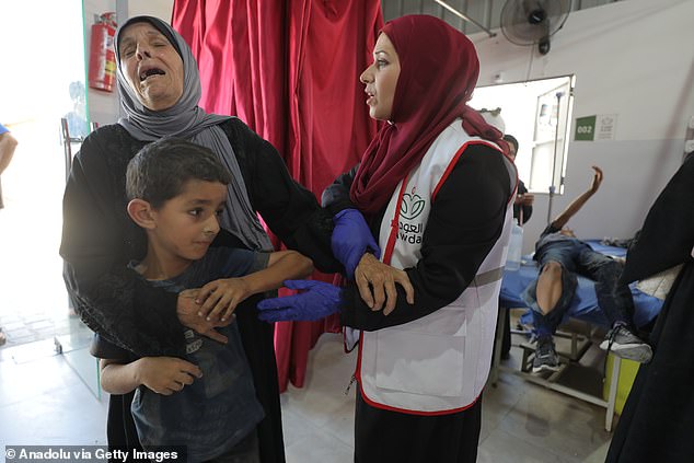 Injured Palestinians, including children, are brought to al-Awda Hospital for medical treatment after Israeli attacks hit a residential building in Nuseirat Refugee Camp in Gaza City, Gaza on July 06, 2025