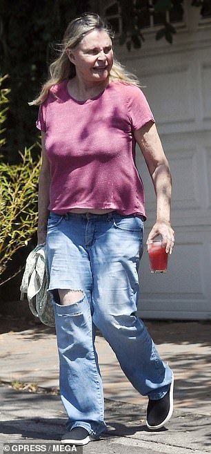 The actress, who wore her long blond hair down, was seen arriving home after making a grocery run
